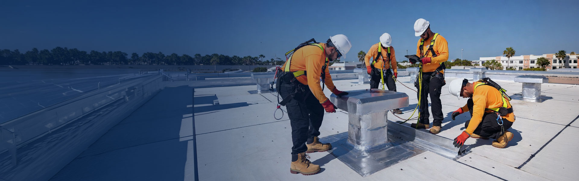 Commercial roof maintenance technicians working on a flat roof in Miami