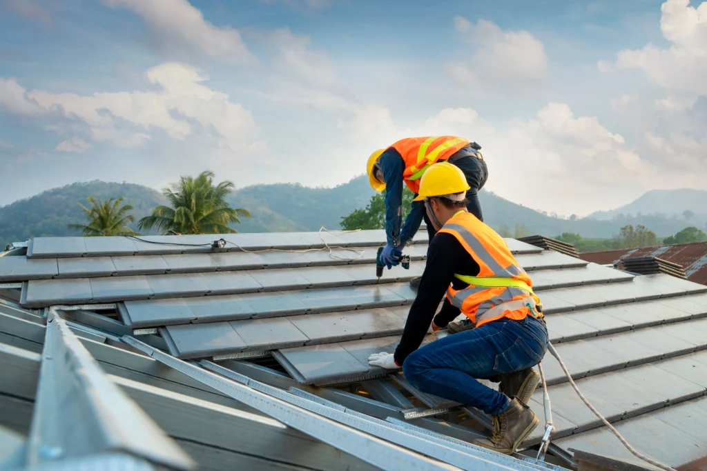 Workers installing solar panels on roof